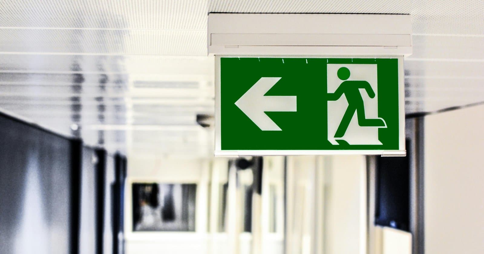 Emergency exit sign in corridor