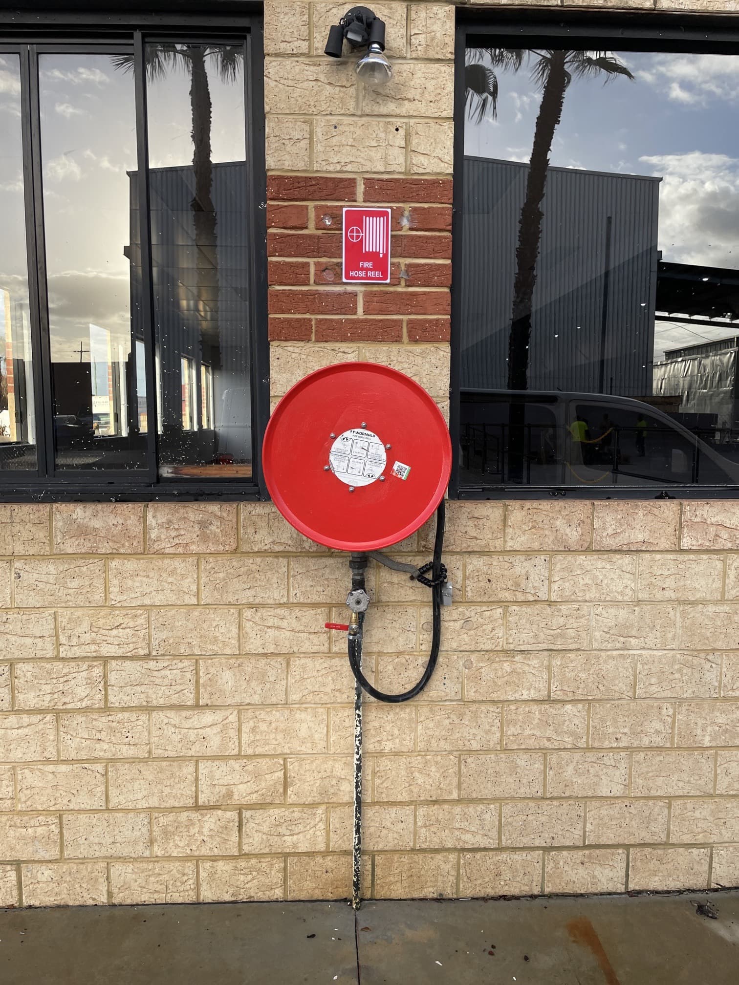 Fire hose reel installation on building wall